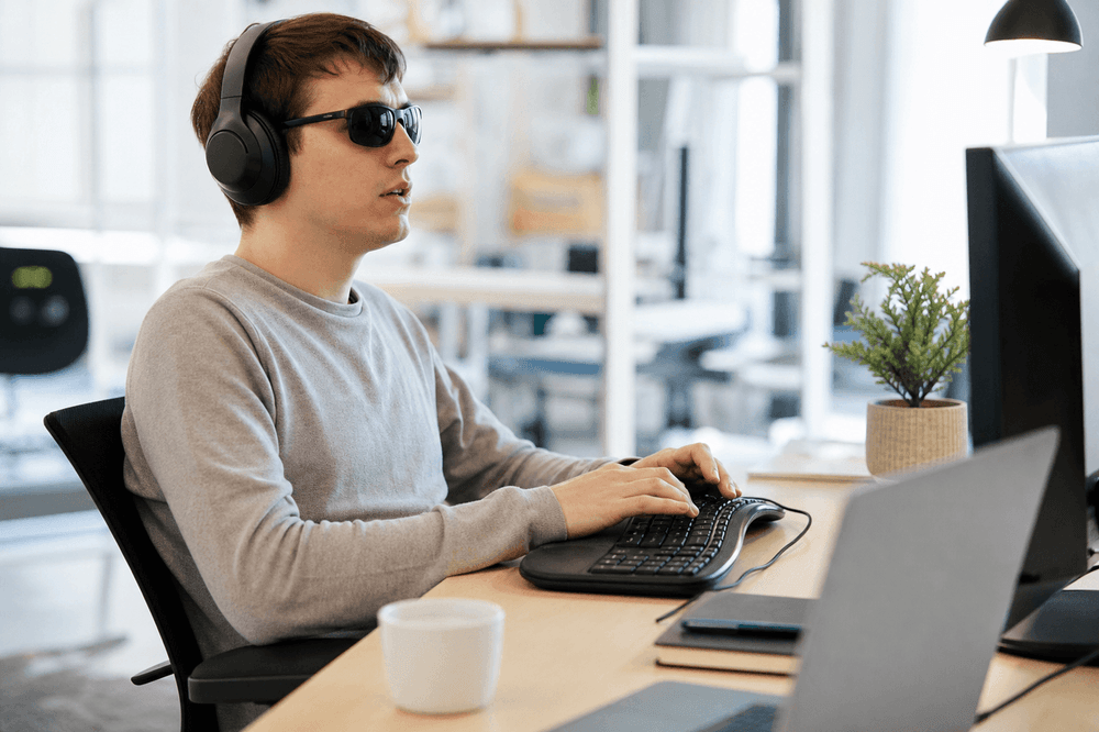 Person using assistive technology at an accessible workstation